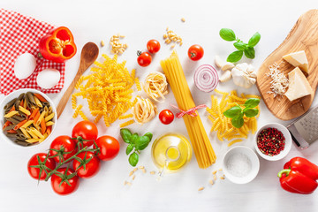 ingredients for italian cousine flat lay, pasta spaghetti penne fusilli tomato oil vegetables