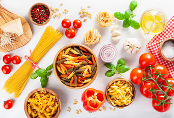 ingredients for italian cousine flat lay, pasta spaghetti penne fusilli tomato oil vegetables