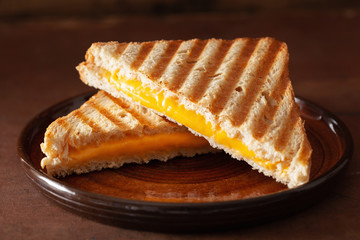 grilled cheese sandwich on rustic brown background