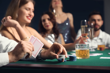 Group of people playing poker in casino