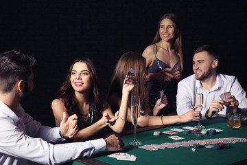 Group of people playing poker in casino