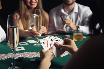 Group of people playing poker in casino
