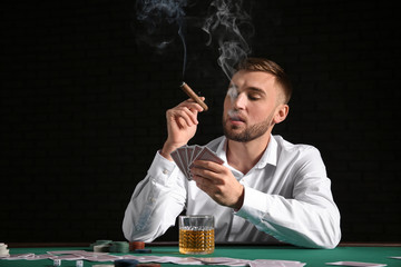 Young man playing poker in casino
