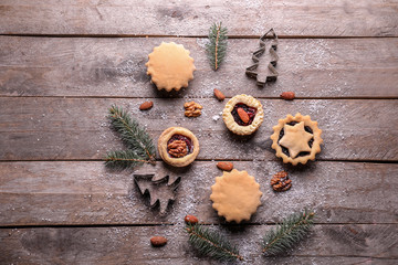 Christmas composition with tasty mince pies on wooden table