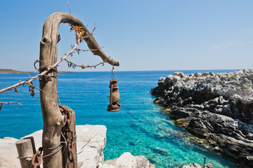 Fototapeta premium Old dusty and rusty lantern above boat dock near Marmara beach, island of Crete, Greece
