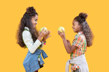 Happy delighted sisters standing opposite each other