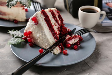 Piece of tasty Christmas cake on grey table