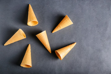 Delicious waffle cones on grey background