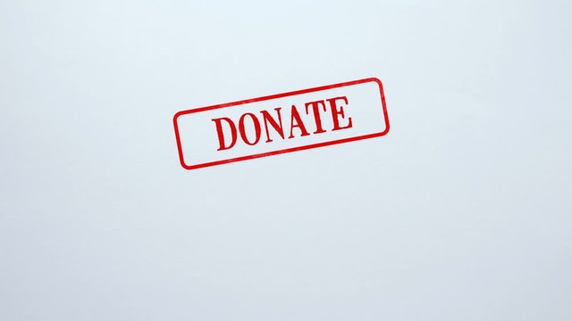Donate red seal stamped on blank paper background, charity project, kindness