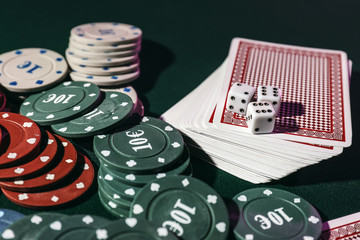 Chips, cards and dices on table in casino
