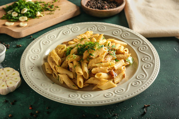 Tasty pasta with sauce and herbs on plate