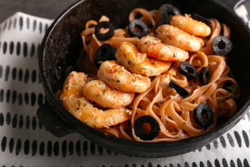 Tasty pasta with shrimps in pan on table, closeup