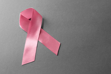 Pink ribbon on grey background. Breast cancer awareness concept