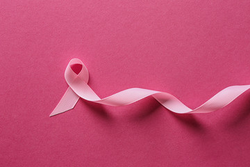 Pink ribbon on color background. Breast cancer awareness concept