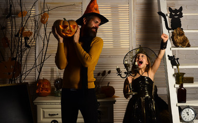 Little girl and wizard man enjoy halloween. Little girl in wizard hat have fun with father. Have a frightfully spooky HalloweenHang around for a spell