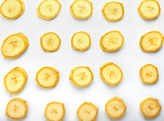 Slices of ripe sweet bananas on white background