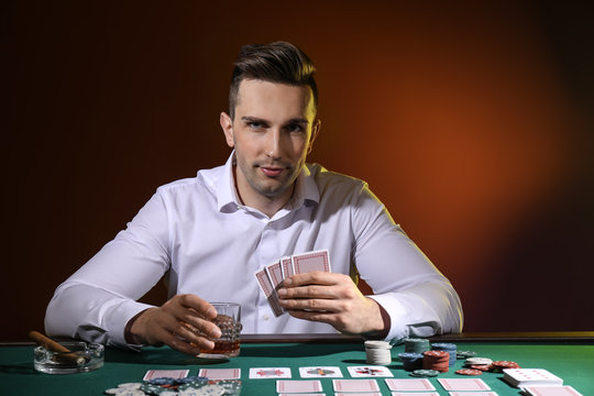 Handsome male player at table in casino