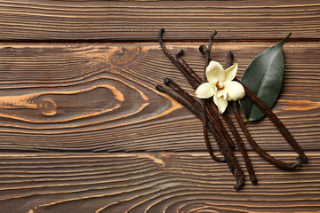 Aromatic vanilla sticks on wooden background