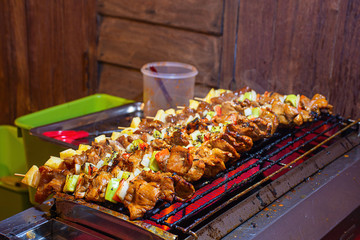 BBQ grilled meat with vegetables and tomato sauces on the steel grilles With the heat.
