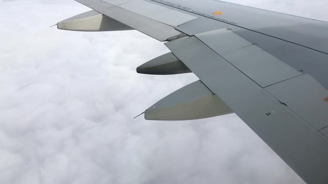 Close Up Airplane Wing Flying Through Clouds