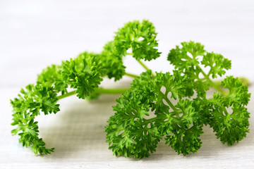 Fototapeta premium fresh curly parsley leaves on the wooden table