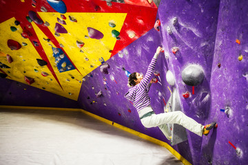 Woman climbing indoor