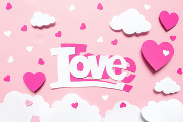 Layout card for the holiday Valentine's Day. Hearts of the word love from paper scrapbooking, origami, handmade on a pink background