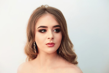 Fototapeta premium Beautiful model girl with Fashion Luxury Makeup, long eyelashes, perfect skin facial make-up. Beauty Brunette model woman holiday make up close up. Eyelash extensions, false eyelashes. Beauty Woman.