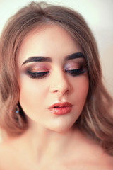 Beautiful model girl with Fashion Luxury Makeup, long eyelashes, perfect skin facial make-up. Beauty Brunette model woman holiday make up close up. Eyelash extensions, false eyelashes. Beauty Woman.