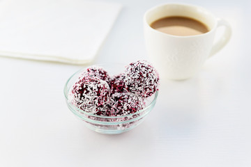 Black currant candies in coconut chips. Proper nutrition