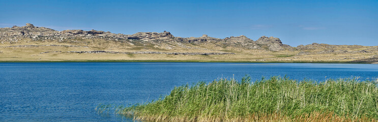 Naklejka premium Beautiful summer steppe landscape and Ayr (Monastyri) Lake, located in stone mountains 