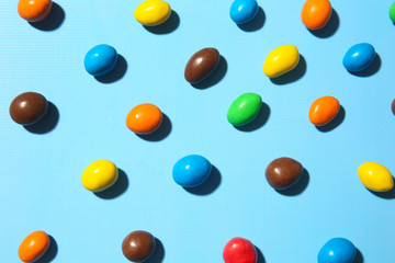 Many colorful candies on color background