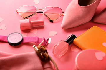 Female accessories on color background