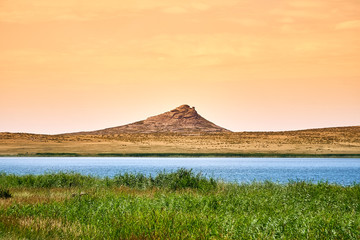 Beautiful summer steppe landscape and Ayr Lake, located in stone mountains "Monasteries" and "Aiyrtau" (1003 meters above sea level), near the town of Ust-Kamenogorsk in East Kazakhstan