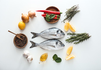 Fresh dorado fish and ingredients on white background