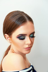 Fototapeta premium Beautiful model girl with Fashion Luxury Makeup, long eyelashes, perfect skin facial make-up. Beauty Brunette model woman holiday make up close up. Eyelash extensions, false eyelashes. 