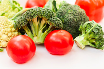Ripe vegetables tomatoes romanesco broccoli on white wooden background with copy space for your text
