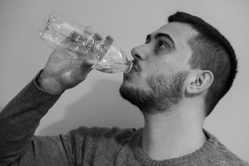Portrait of a young boy drinking water.
