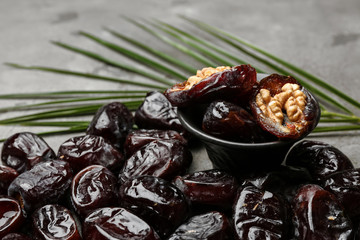 Bowl with sweet dried dates on table