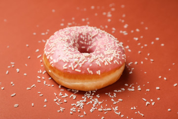 Sweet tasty donut on color background