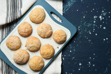 Board with tasty cookies on color table