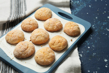 Board with tasty cookies on color table
