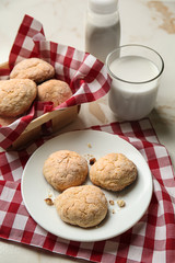 Tasty cookies with milk on light table