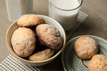 Tasty cookies with milk on grey table