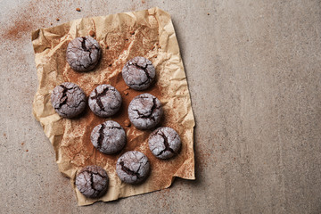 Parchment with tasty chocolate cookies on table