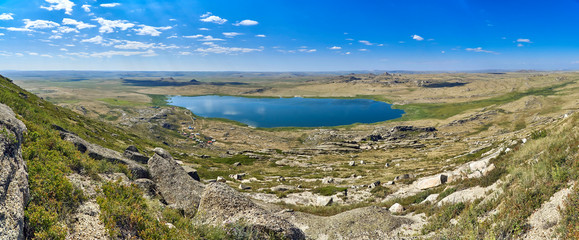 Beautiful summer steppe landscape and Ayr (Monastyri) Lake, located in stone mountains 