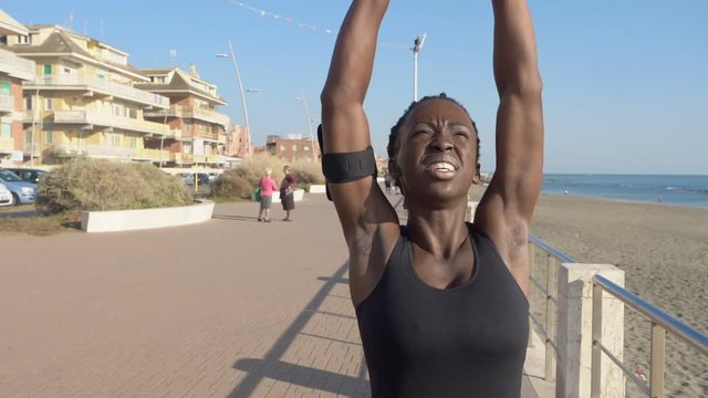 excel yourself,challenge,sport. Black woman doing strectching befor run