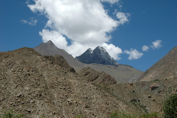 Tibetan mountains against the blue sky and clouds