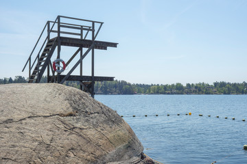 Fototapeta na wymiar One of Stockholm's finest bathing beaches with, sandy beach, rocky bath, jumping tower and more