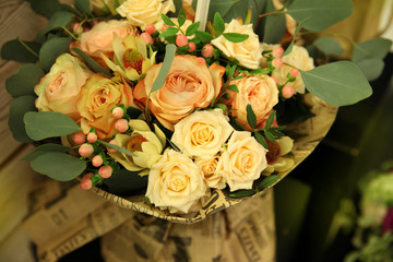 Beautiful delicate bouquet of cream and peach roses in vintage style